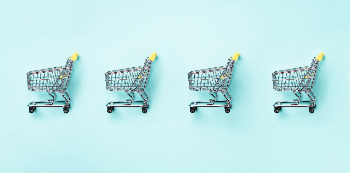 four shopping carts lined up in a row on a turquoise background